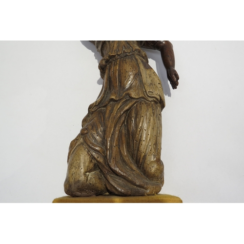 7238 - A 17th Century carved fruit wood female figure with hand aloft, elements maybe missing from back, wo... 