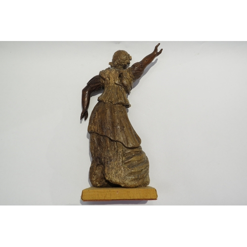 7238 - A 17th Century carved fruit wood female figure with hand aloft, elements maybe missing from back, wo... 