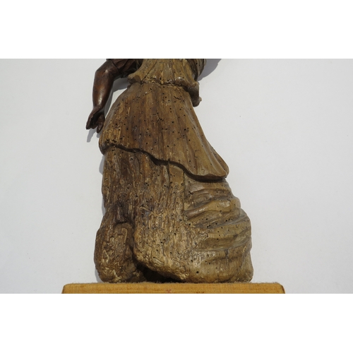 7238 - A 17th Century carved fruit wood female figure with hand aloft, elements maybe missing from back, wo... 