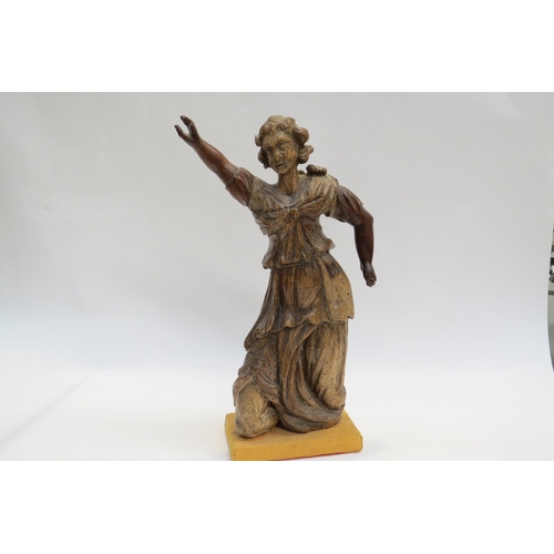 7238 - A 17th Century carved fruit wood female figure with hand aloft, elements maybe missing from back, wo... 