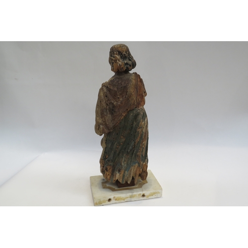 7240 - A 17th Century European carved lime wood figure of a saint in a time worn state mounted on a marble ... 