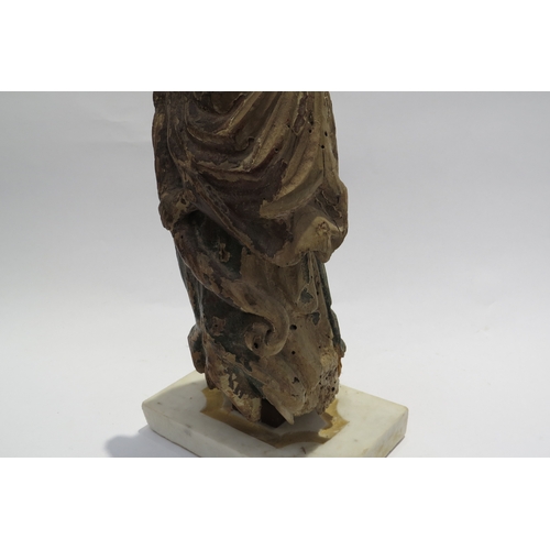 7240 - A 17th Century European carved lime wood figure of a saint in a time worn state mounted on a marble ... 