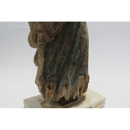 7240 - A 17th Century European carved lime wood figure of a saint in a time worn state mounted on a marble ... 