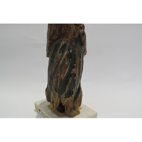 7240 - A 17th Century European carved lime wood figure of a saint in a time worn state mounted on a marble ... 