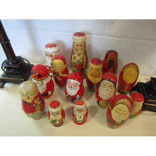 1103 - Fourteen Christmas related Russian dolls including various Santa examples