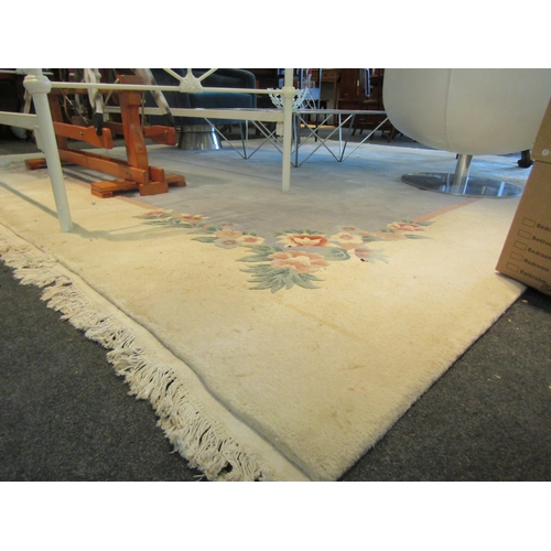 1107 - A large Chinese rug, blue and cream ground with foliate design and tasselled ends, 360cm x 335cm