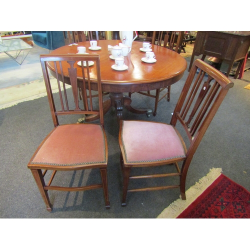 1161 - A set of four Edwardian mahogany dining chairs, inlaid splat back, pink velour studded seats, raised... 