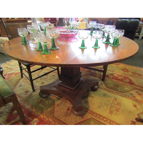 1174 - A William IV drop-flap circular breakfast table with quatreform base, 72cm tall x 124cm diameter