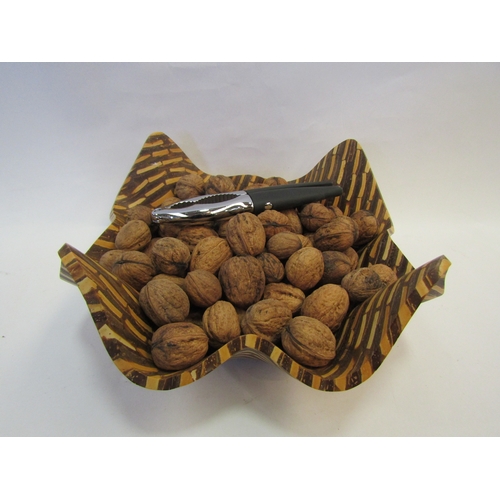 1230 - A handkerchief shape wooden style bowl containing walnuts and nutcrackers  (R) £0