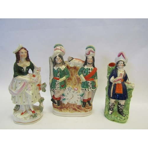 1239 - Three 19th Century Staffordshire figural groups to include clock group flanked by gentlemen in plume... 