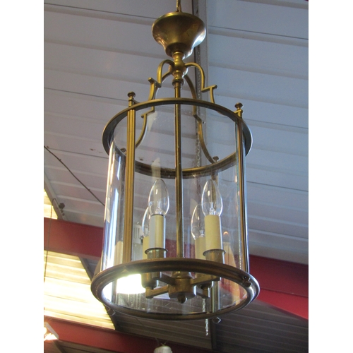 1243 - A pair of Georgian style brass pendant lights with curved glass shades   (R) £150