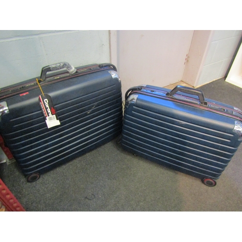 1297 - Two Corona, wheeled lightly used suitcases, medium and large.  Both with keys.  Combination code: 01... 