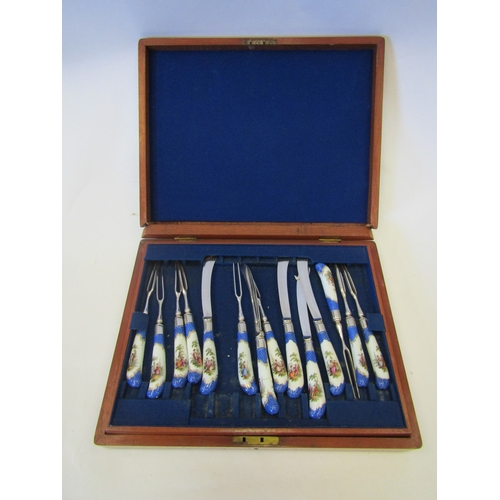 1324 - A cased set of twelve porcelain pistol grip handled forks and knives (one fork missing)