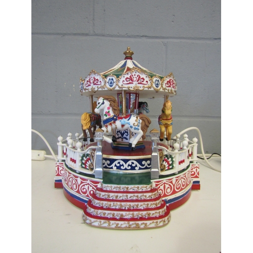 1326 - A light-up revolving Christmas gallopers, 24cm tall