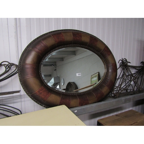 2140 - An oval leather framed wall mirror