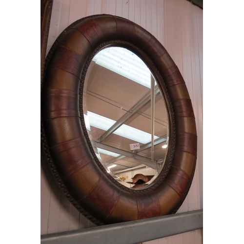 2140 - An oval leather framed wall mirror