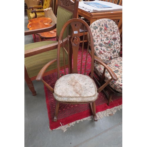 2408 - An Ercol rocking armchair with swan to splat        (E) £10-15