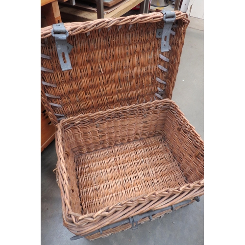 2058 - A vintage wicker basket with metal lock and latch fixings the base stamped GR 1937