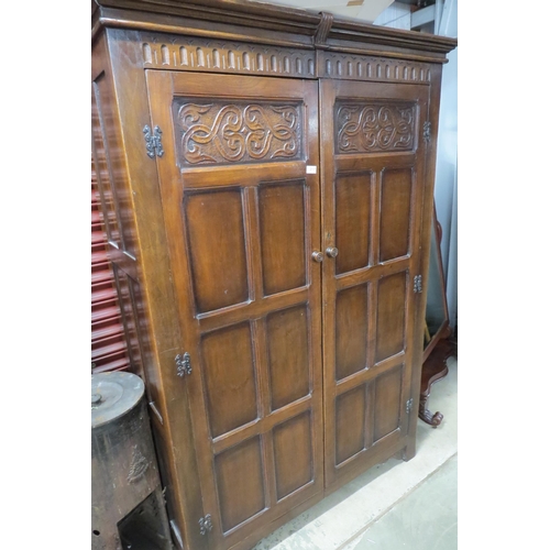 2117 - A carved oak two door wardrobe    (R)  £30