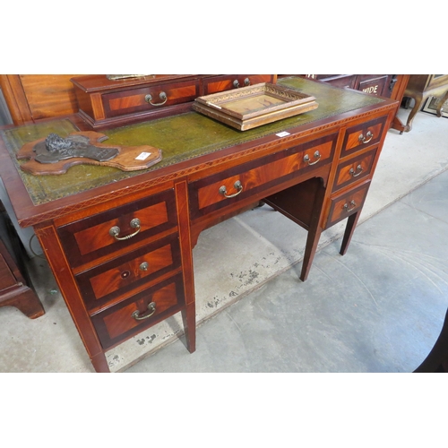 2128 - An Edwardian inlaid mahogany nine drawer desk with a leather insert top