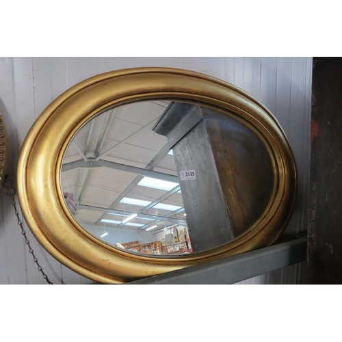 2135 - An oval gilt framed wall mirror