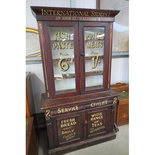 2136 - A Victorian mahogany shop cabinet painted International Stores LTD, in two sections