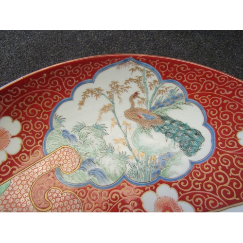 1486 - A Chinese charger in famille rose colour palette, panels of birds and flowers, 46cm diameter    (R) ... 