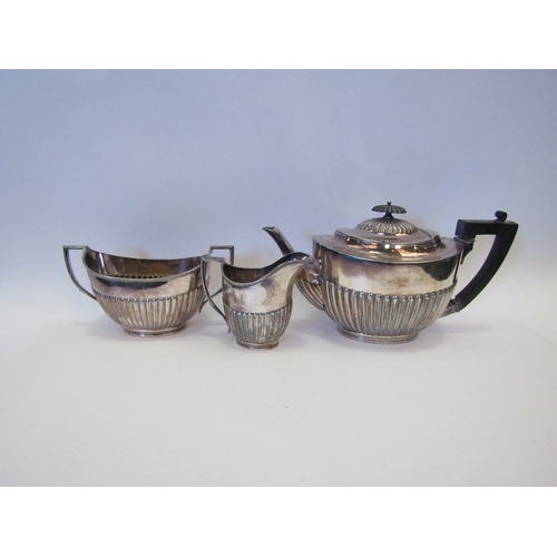 1525 - A three piece EPBM teaset with gadrooned design, ebony knop and handle and a similar coffee pot (4)