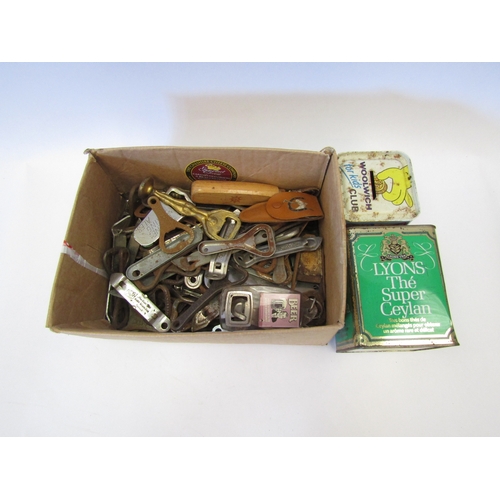 1544 - A quantity of bottle openers and two vintage tins