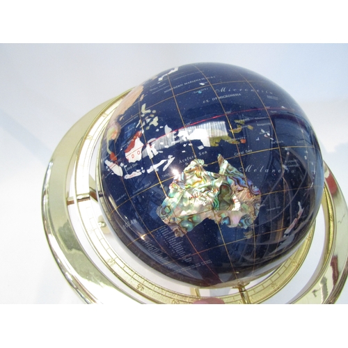 1556 - A gemstone World globe on brass effect gimbal stand