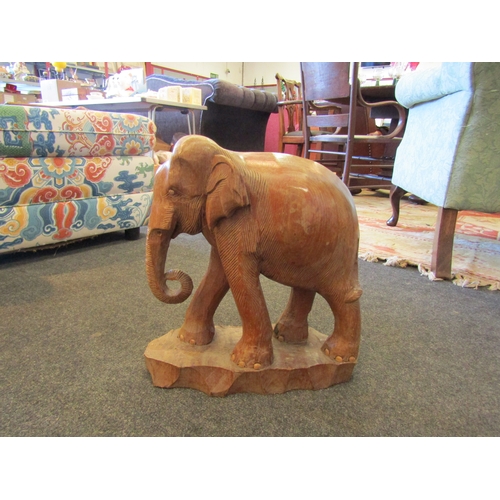 1563 - A wooden elephant figure on base, 37cm tall