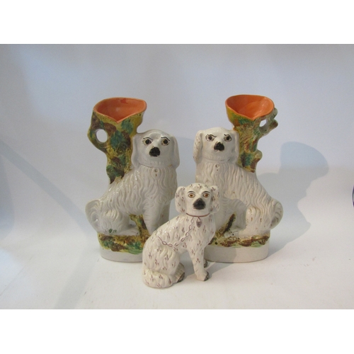 1564 - A pair of 19th Century Staffordshire spill vases as seated dogs, 32cm tall, a single Staffordshire d... 