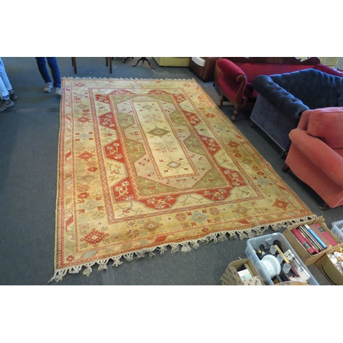 1593 - A large cream ground Turkish Melas rug with multiple borders and tasselled ends, 12ft x 9ft