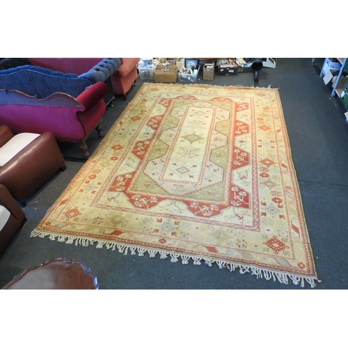 1593 - A large cream ground Turkish Melas rug with multiple borders and tasselled ends, 12ft x 9ft