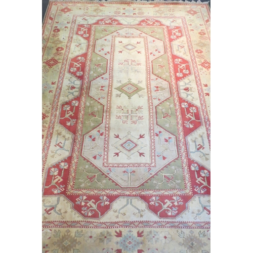 1593 - A large cream ground Turkish Melas rug with multiple borders and tasselled ends, 12ft x 9ft