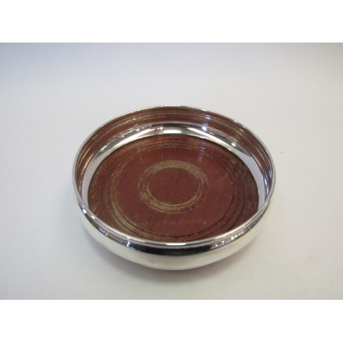 1417 - A silver turned wood base bottle coaster, Birmingham 1979, diameter, 13.5cm