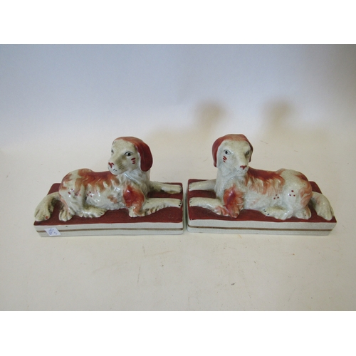 1476 - A pair of 19th Century rust coloured recumbent Staffordshire dogs, 14.5cm long