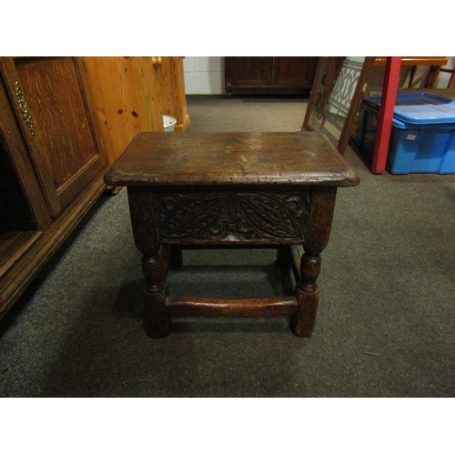 1068 - A 19th Century and later carved oak stool with lift-up top, 38cm tall x 44cm wide x 27cm deep