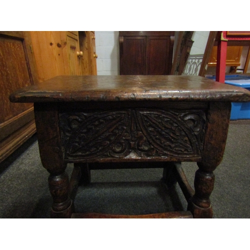 1068 - A 19th Century and later carved oak stool with lift-up top, 38cm tall x 44cm wide x 27cm deep