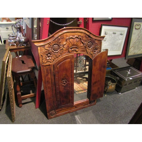 1073 - A large carved wall mirror with two doors, 99cm x 75cm