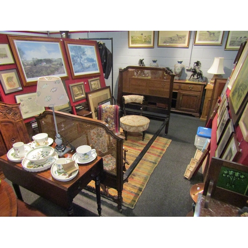 1123 - An Edwardian walnut bergere bed frame on brass castors with bobbin turned stretcher and side rails  ... 