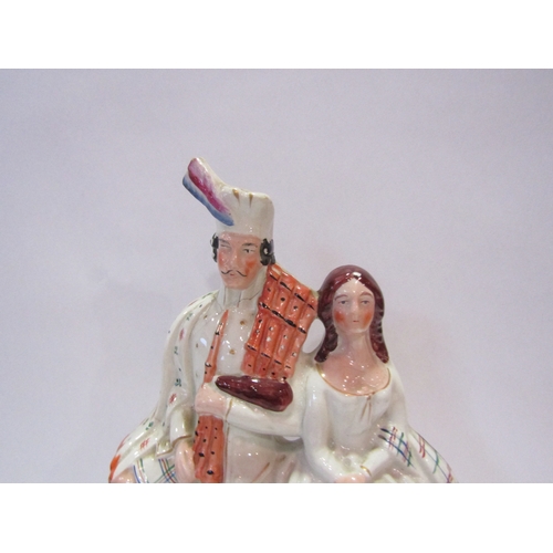 1233 - A 19th Century clock figural group, a highlander with bagpipes sat beside female, 35cm tall (a/f)