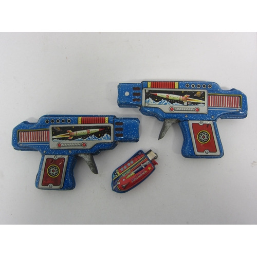 9076 - Two SY Toys (Yoneya), Japan, tinplate friction space guns in blue with litho printed images of rocke... 