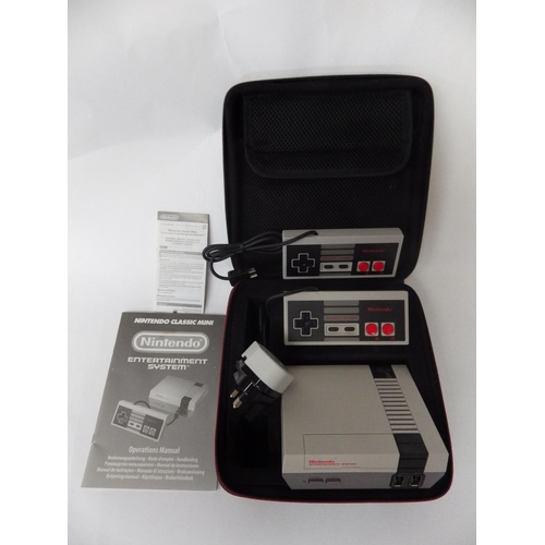 9027 - A NES mini containing 30 retro games and two controllers, along with Pac-Man and Frogger TV arcade s... 