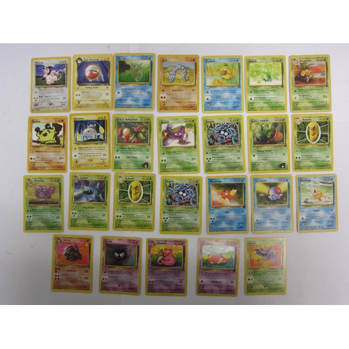 9019 - A collection of assorted Pokemon cards including base set Shadowless Holo Charizard (heavily worn), ... 