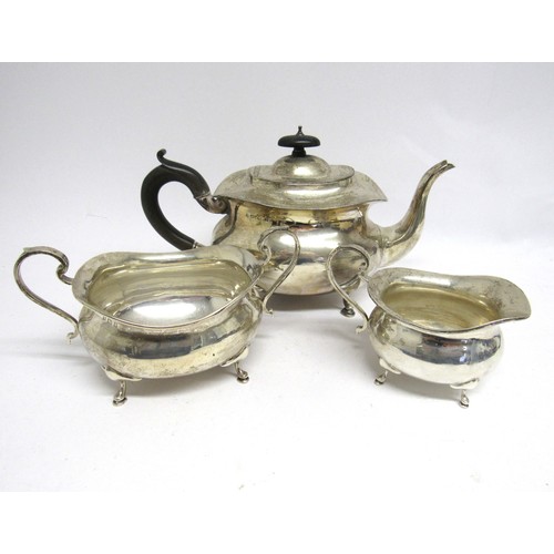 7452 - A Stewart Dawson & Co Ltd silver three piece teaset, teapot, scroll handle, hoof feet, 16cm tall x 2... 