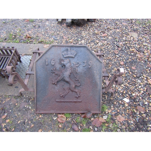 3250 - A 1639 dated cast iron fireback with rampant lion design, a pair of dogs and a fire basket