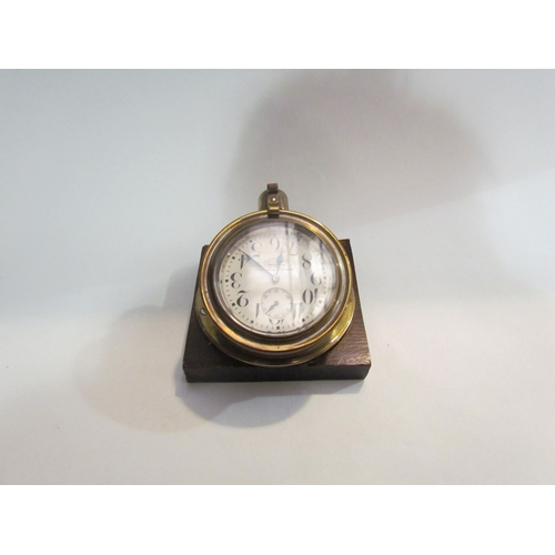 4407 - A Winsor Bishop of Norwich vintage brass cased automobile clock marked Doxa, 7cm face, on wooden pli... 