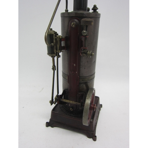 9554 - A Bing style stationary engine, maroon painted cast iron base with vertical boiler with chimney, pow... 