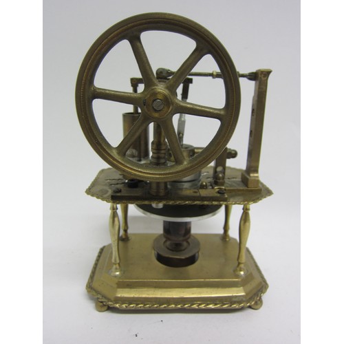 9537 - A Stirling hot air stationary engine with 8.5cm diameter flywheel, on ornate brass two tier frame wi... 